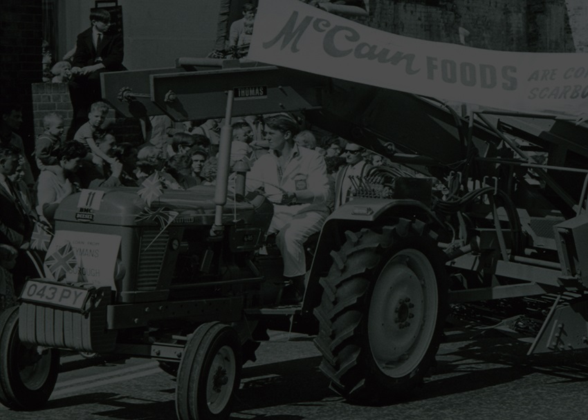Historical black & white photo - Tractor going down road in Scarborough UK