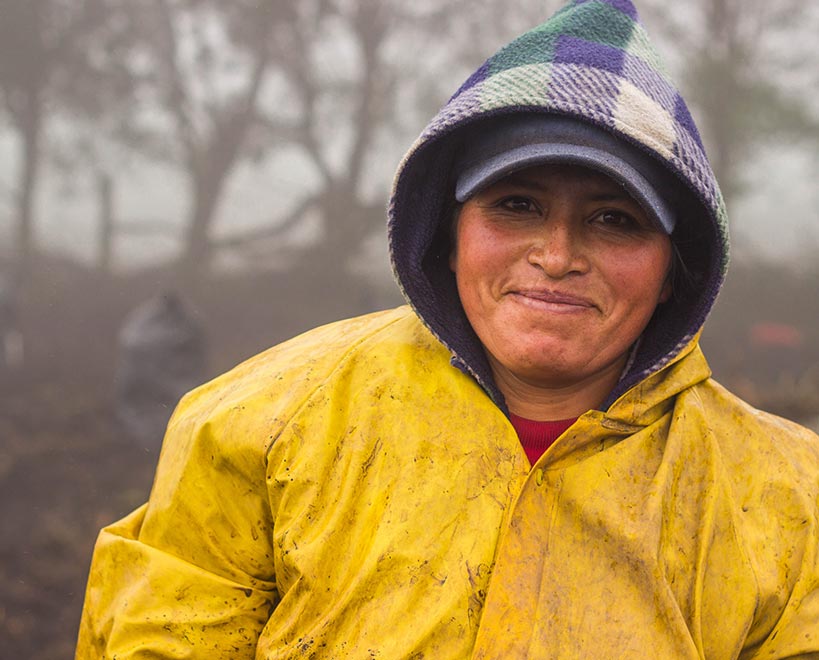 Person stood with raincoat on in farming field
