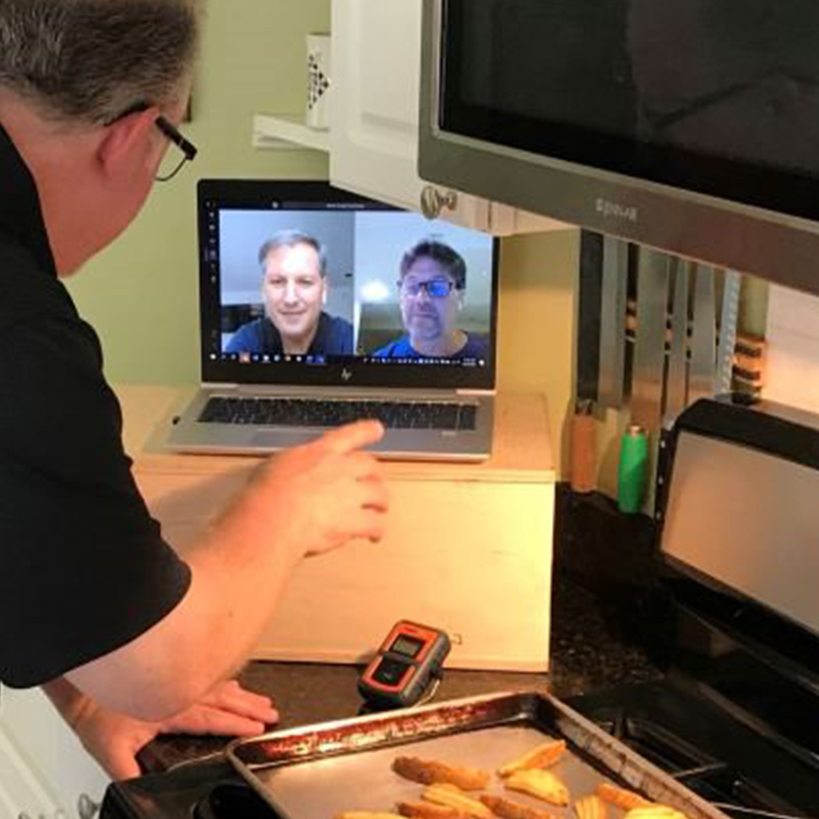 Person test cooking in kitchen, and sharing learning with those on video call