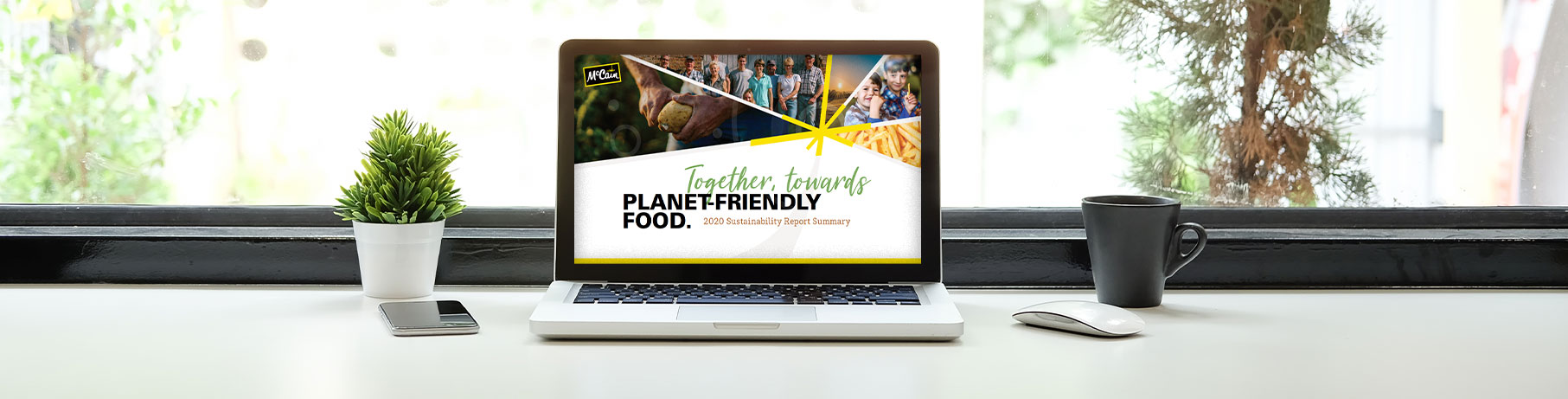 McCain Foods '2020 Sustainability Report' on laptop.
