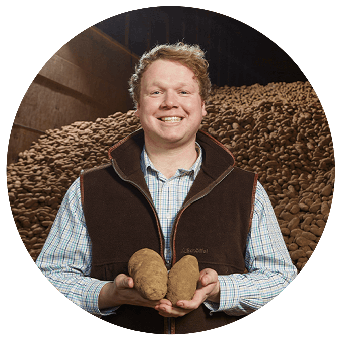 McCain Foods agriculture team member holding potatoes