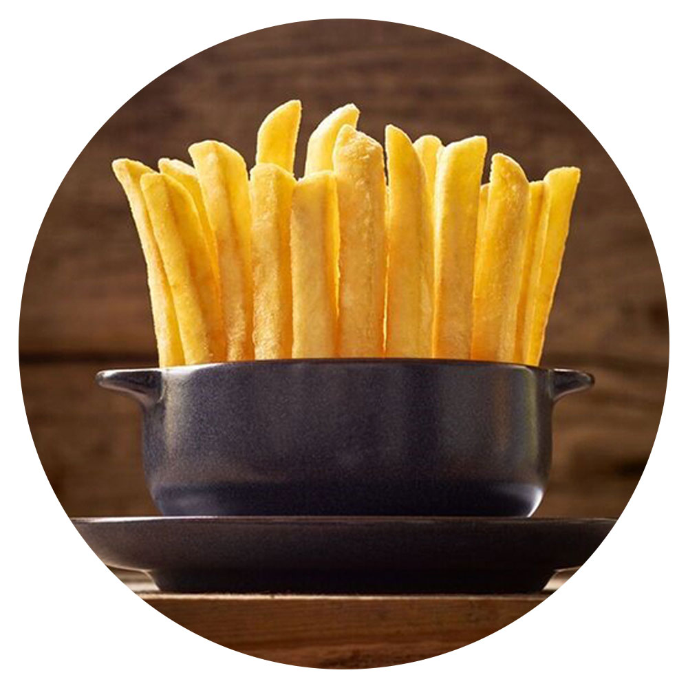A bowl of French fries on a table. The French fries are standing vertically upright in the bowl.